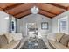Open living area with high ceilings, showing access to the kitchen and dining area at 27623 Lisa Dr, Tavares, FL 32778
