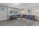 Bright living room with gray sofas, a large mirror, and a cozy atmosphere at 27623 Lisa Dr, Tavares, FL 32778