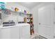 Laundry room with washer, dryer, and storage shelves at 4034 Dinner Lake Way, Lake Wales, FL 33859