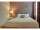 Bright bedroom with a double bed, nightstands, and decorative wall art at 4565 Cabello Loop, Kissimmee, FL 34746