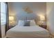 Comfortable bedroom with a double bed, nightstands, and elegant wall decor at 4565 Cabello Loop, Kissimmee, FL 34746