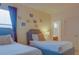 Playful bedroom with twin beds, nightstand, and fun wall decor at 4565 Cabello Loop, Kissimmee, FL 34746
