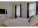 Bedroom with a king-size bed, dresser, and large TV at 4565 Cabello Loop, Kissimmee, FL 34746