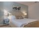 Bedroom with a king-size bed, light beige headboard and nightstands with lamps at 4565 Cabello Loop, Kissimmee, FL 34746