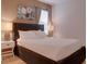 Bedroom with a queen-size bed, dark headboard, and nightstands at 4565 Cabello Loop, Kissimmee, FL 34746