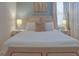 Bedroom with a queen-size bed, nightstands, and window with blinds at 4565 Cabello Loop, Kissimmee, FL 34746