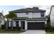 Two-story home with dark gray accents and landscaping at 4565 Cabello Loop, Kissimmee, FL 34746