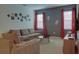 Gathering room features a sectional sofa and red curtains at 4565 Cabello Loop, Kissimmee, FL 34746