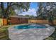 Inviting kidney-shaped pool with brick house and wooden fence at 602 Lyman St, Ocoee, FL 34761