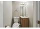 Clean bathroom with a single sink vanity, toilet, and wood cabinet at 707 Saint Matthew Cir, Altamonte Springs, FL 32714