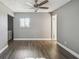 Simple bedroom with wood-look floors, ceiling fan, and neutral walls at 707 Saint Matthew Cir, Altamonte Springs, FL 32714