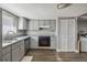 Bright kitchen features gray cabinets, stainless steel appliances, and wood-look floors at 707 Saint Matthew Cir, Altamonte Springs, FL 32714