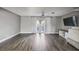 Bright living room, featuring wood-look floors and sliding glass doors at 707 Saint Matthew Cir, Altamonte Springs, FL 32714