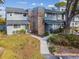 Two-story townhouse with gray siding, brick chimney, and walkway at 707 Saint Matthew Cir, Altamonte Springs, FL 32714