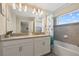 Bathroom with double vanity, bathtub, and shower at 820 Pebble Beach Dr, Davenport, FL 33896