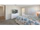 Bedroom with dresser, TV, and bed with coastal bedding at 820 Pebble Beach Dr, Davenport, FL 33896