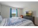 Bedroom with king-size bed, TV, and orange armchair at 820 Pebble Beach Dr, Davenport, FL 33896