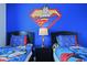 Twin bedroom with Superman theme and nightstand at 820 Pebble Beach Dr, Davenport, FL 33896