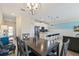 Dining area with a chandelier and view of the kitchen and living room at 820 Pebble Beach Dr, Davenport, FL 33896