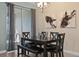 Elegant dining room with a dark wood table, bench seating for six at 820 Pebble Beach Dr, Davenport, FL 33896