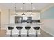 Modern kitchen with white cabinets, stainless steel appliances, and breakfast bar at 820 Pebble Beach Dr, Davenport, FL 33896