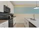 Modern kitchen with white cabinets, stainless steel appliances, and island at 820 Pebble Beach Dr, Davenport, FL 33896