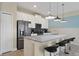 Modern kitchen with white cabinets, stainless steel appliances, and breakfast bar at 820 Pebble Beach Dr, Davenport, FL 33896