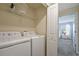 Laundry room with washer, dryer, and shelving at 820 Pebble Beach Dr, Davenport, FL 33896