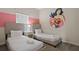 Twin bedroom with two beds, nightstand, and fun decor at 830 Pebble Beach Dr, Davenport, FL 33896