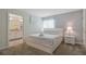 Bedroom with a queen bed, en-suite bathroom, and a nightstand at 830 Pebble Beach Dr, Davenport, FL 33896
