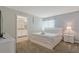 Bedroom with a queen bed, en-suite bathroom, and a nightstand at 830 Pebble Beach Dr, Davenport, FL 33896