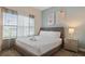 King-size bedroom with nightstand and large window at 830 Pebble Beach Dr, Davenport, FL 33896