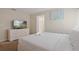Bedroom with a queen bed, dresser, and en-suite bathroom at 830 Pebble Beach Dr, Davenport, FL 33896