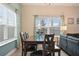 Bright dining room with table and chairs, near the living room at 830 Pebble Beach Dr, Davenport, FL 33896