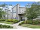 Modern two-story townhome with stone accents and landscaped front yard at 830 Pebble Beach Dr, Davenport, FL 33896