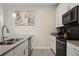 Modern kitchen with stainless steel appliances and gray countertops at 830 Pebble Beach Dr, Davenport, FL 33896