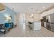 Open concept kitchen features a large island, stainless steel appliances, and white cabinets at 830 Pebble Beach Dr, Davenport, FL 33896