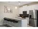 Modern kitchen with stainless steel appliances and an island with seating at 830 Pebble Beach Dr, Davenport, FL 33896