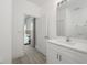 Bathroom with vanity, quartz countertop and view into bedroom at 991 S Delaware Ave, Deland, FL 32720