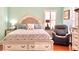 Main bedroom with a king-size bed, recliner chair and soft colors at 1133 Indigo Dr, Celebration, FL 34747