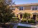Front view of tan townhome with sidewalk and landscaping at 13228 Daniels Landing Cir, Winter Garden, FL 34787