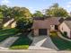 Aerial view of a condo with a one car garage and mature landscaping at 175 Golf Club Dr # 175, Longwood, FL 32779