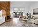 Bright living room with a large brick fireplace, hardwood floors and access to a patio at 175 Golf Club Dr # 175, Longwood, FL 32779