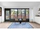 Sunroom with a wall of windows, wicker chairs, and a view of the backyard at 175 Golf Club Dr # 175, Longwood, FL 32779