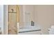 Bathroom with soaking tub, shower, and gold accents at 306 Burleigh St, Orlando, FL 32824