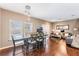 Open concept living and dining area with hardwood floors, gray furniture and a large dining table at 3212 Cupid Pl, Kissimmee, FL 34747