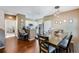 Dining area with hardwood floors, gray chairs, and kitchen views at 3212 Cupid Pl, Kissimmee, FL 34747