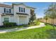 Townhome with walkway, landscaping, and a light-colored exterior at 3212 Cupid Pl, Kissimmee, FL 34747