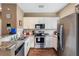 Modern kitchen with granite countertops and stainless steel appliances at 3212 Cupid Pl, Kissimmee, FL 34747