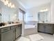 Luxurious bathroom with double vanity and a large soaking tub at 4408 Renly Ln, Clermont, FL 34711